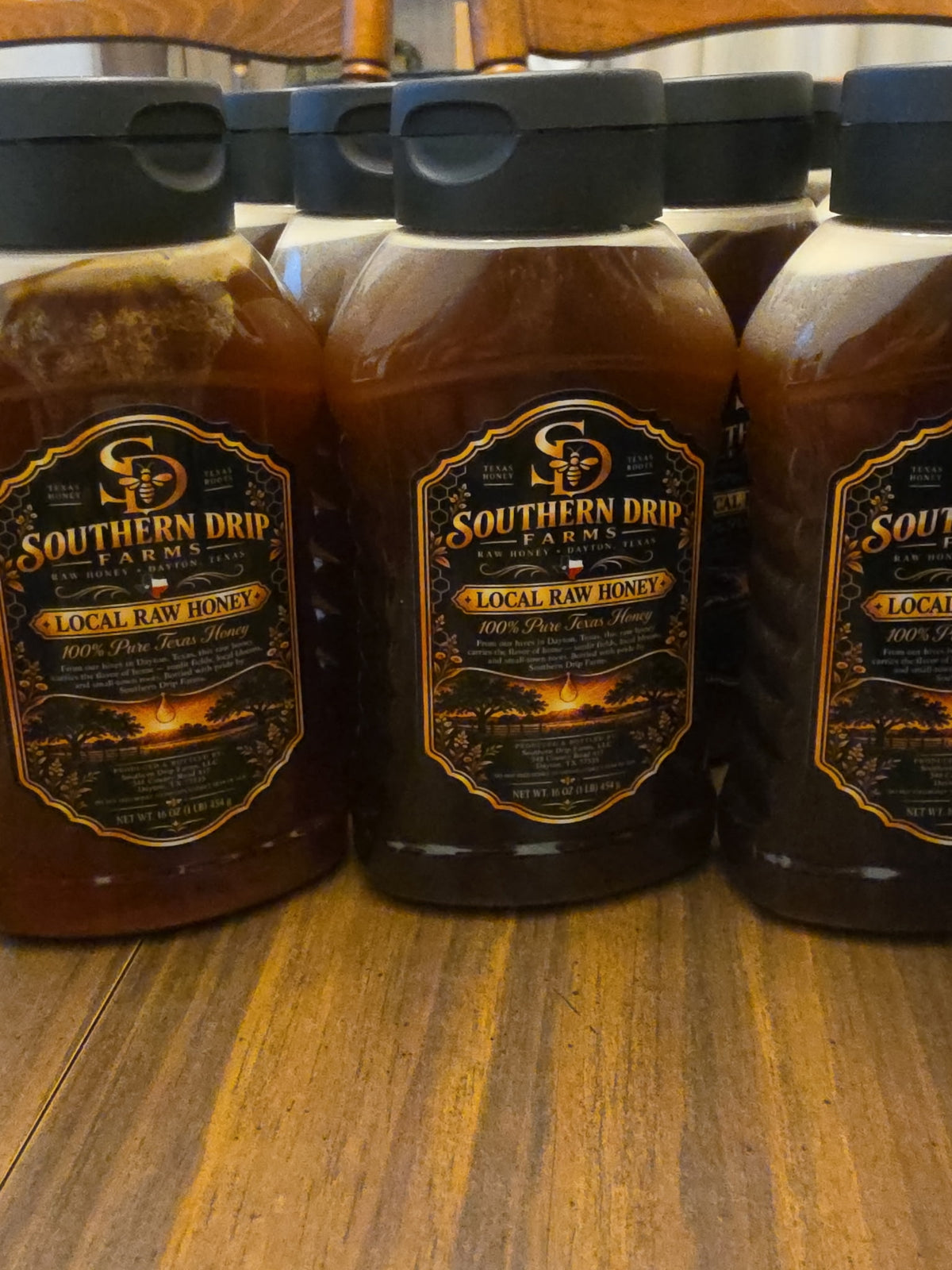 Filled Southern Drip Farms honey bottles ready for customers