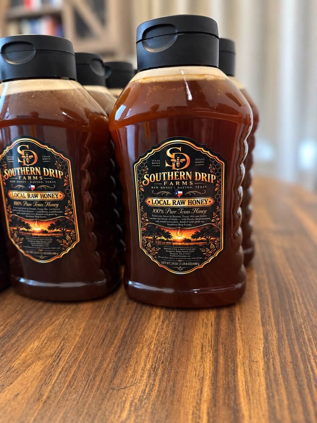 Southern Drip Farms honey bottles with black and gold labels